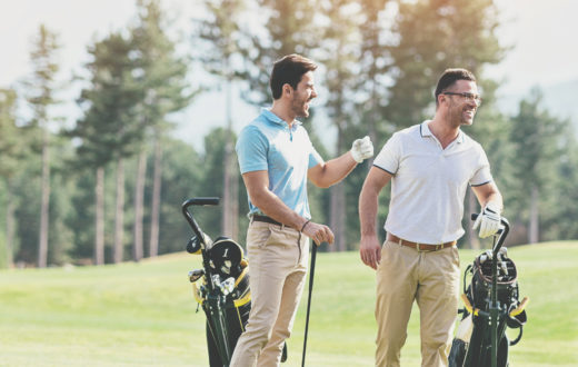 Three men playing golf