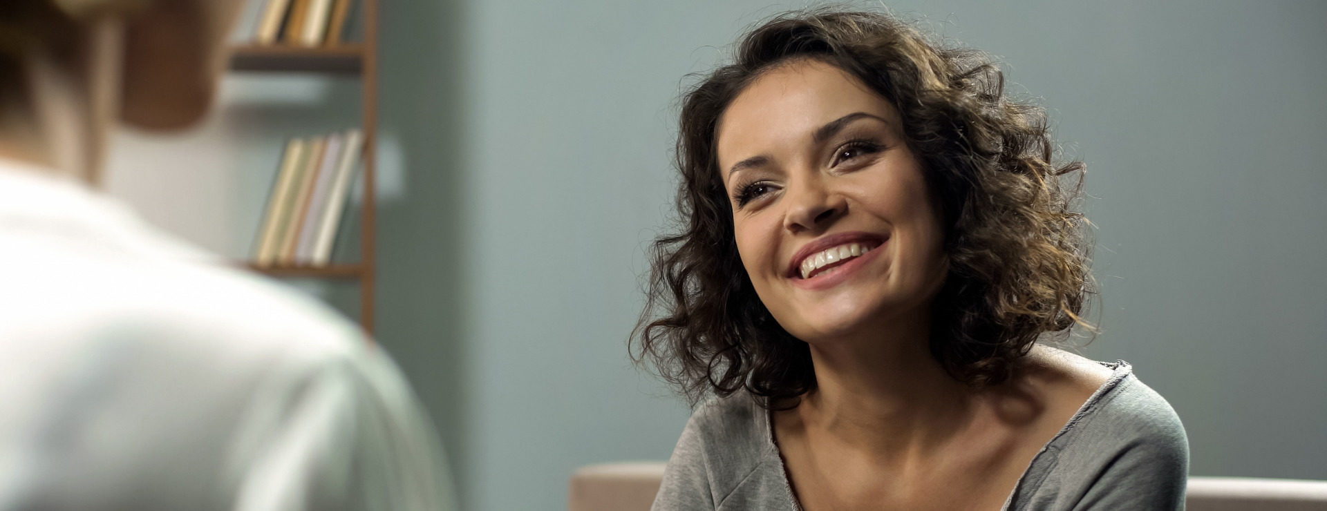 A patient smiling at her consultant after oral surgery at KIMS Hospital, Kent