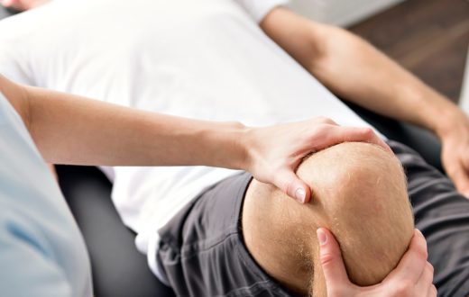 Physical therapy on a patients knee after a sporting event