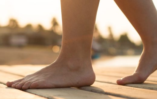 Person walking along the beach bare feet