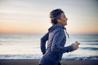 Woman running along beach front