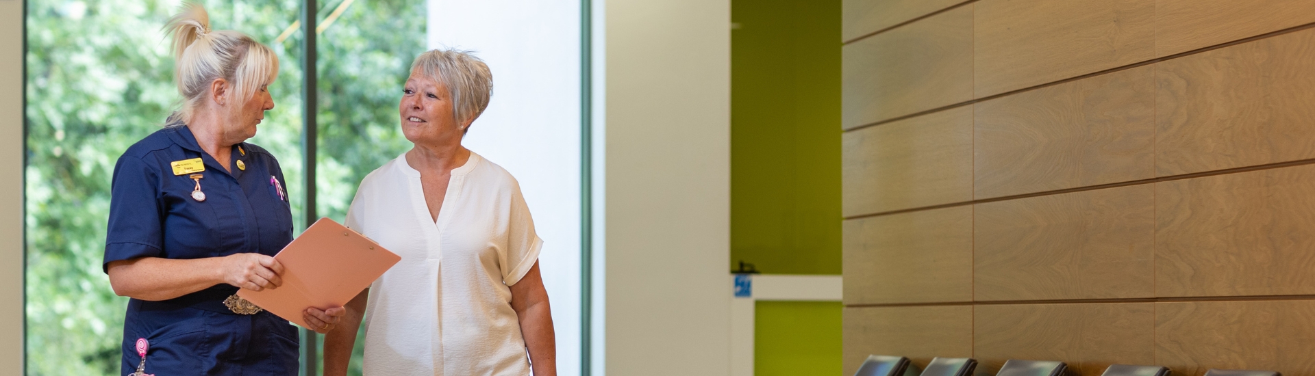 Patient and nurse walking down a corridor
