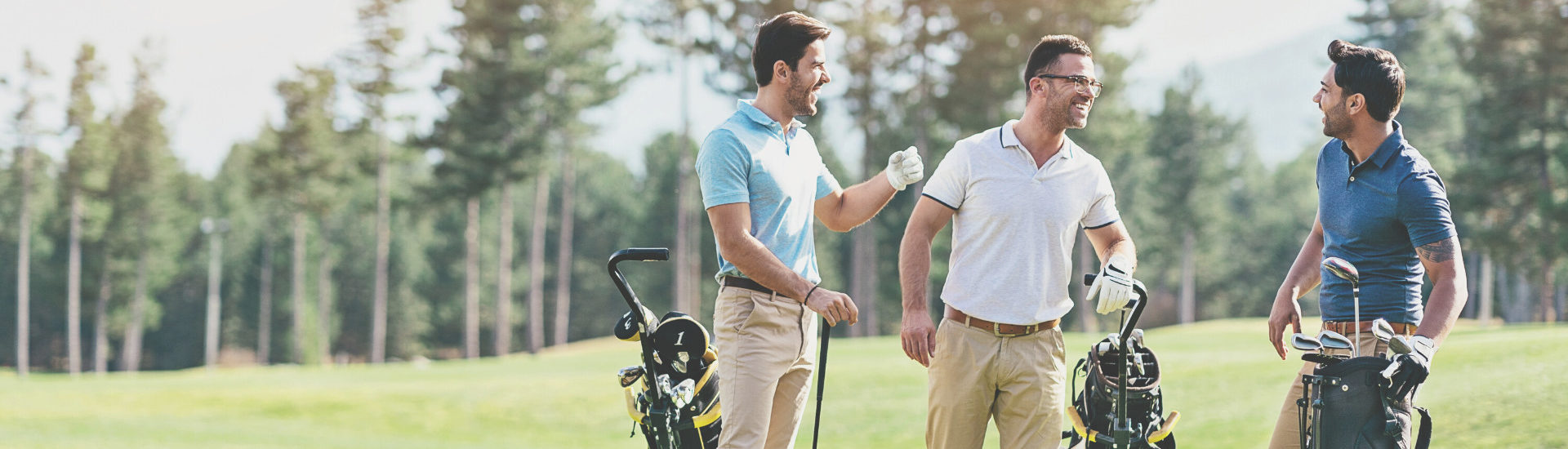 Group of men playing golf.