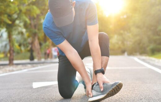man experiencing foot pain while on a run