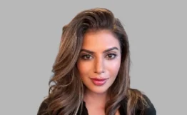 Dr Anisha Arora, female Private GP in the UK with expertise in preventative medicine and health screening, smiling in professional portrait.