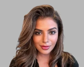 Dr Anisha Arora, female Private GP in the UK with expertise in preventative medicine and health screening, smiling in professional portrait.