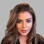 Dr Anisha Arora, female Private GP in the UK with expertise in preventative medicine and health screening, smiling in professional portrait.