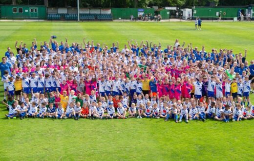 Large group photo of Bearsted FC players on a pitch celebrating their 2025/26 partnership with KIMS Hospital.